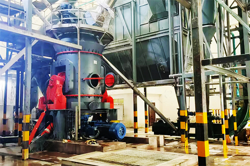 Large grinding mill being transported on a flatbed truck